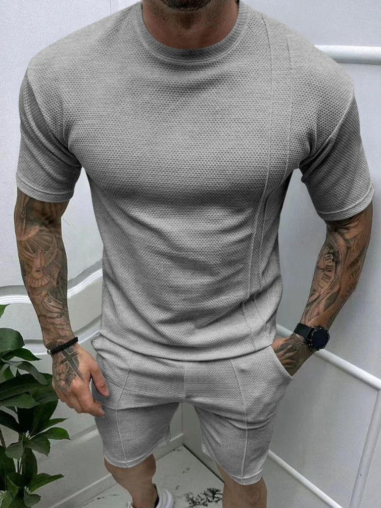  man wearing Barevici Haven Set tee and shorts set, shirt front view light grey