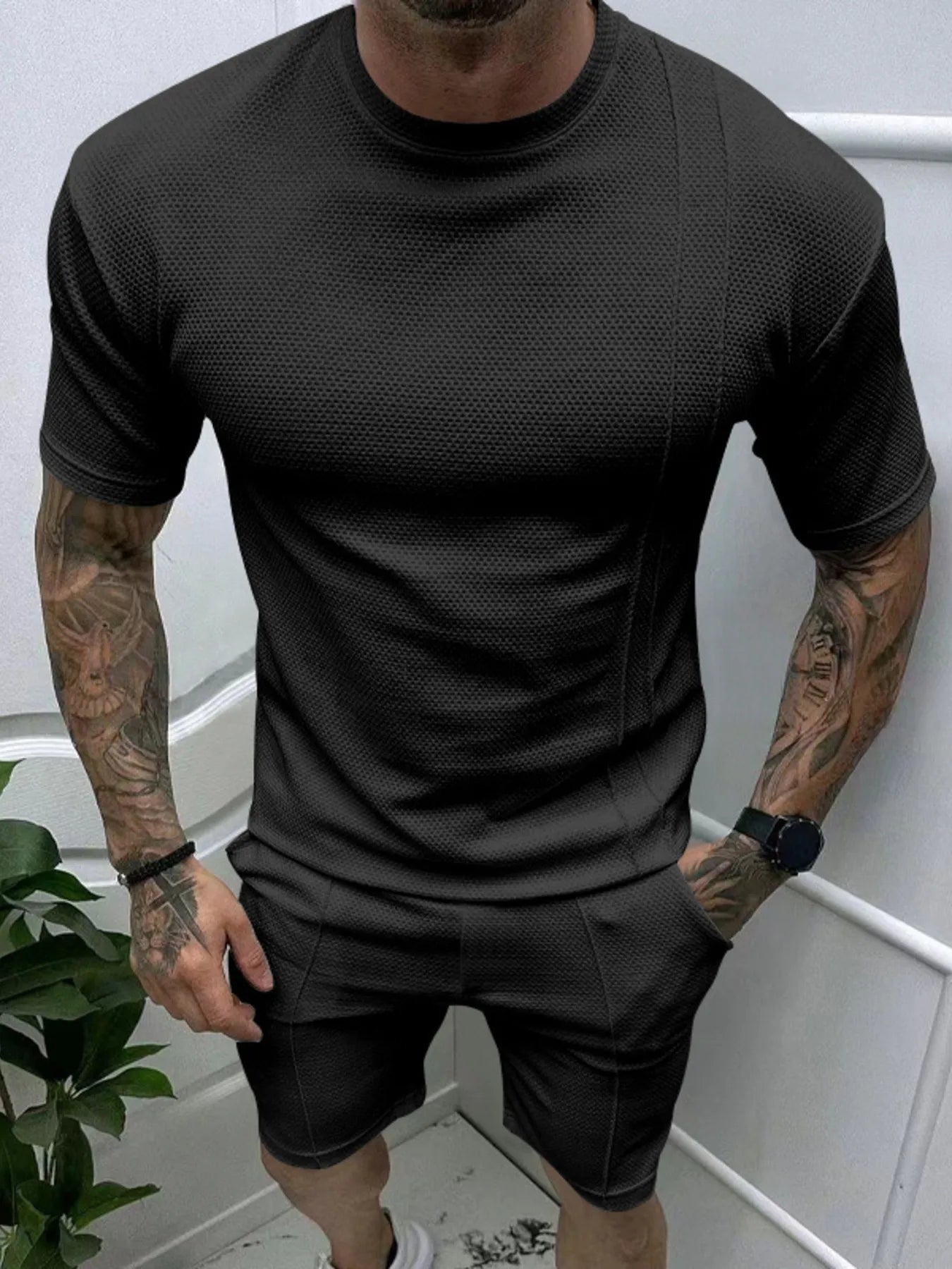  man wearing Barevici Haven Set tee and shorts set, shirt front view black