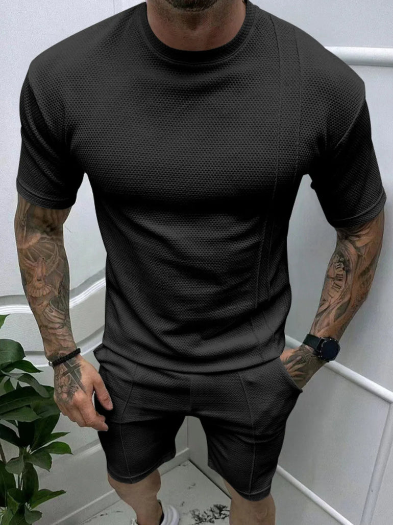  man wearing Barevici Haven Set tee and shorts set, shirt front view black