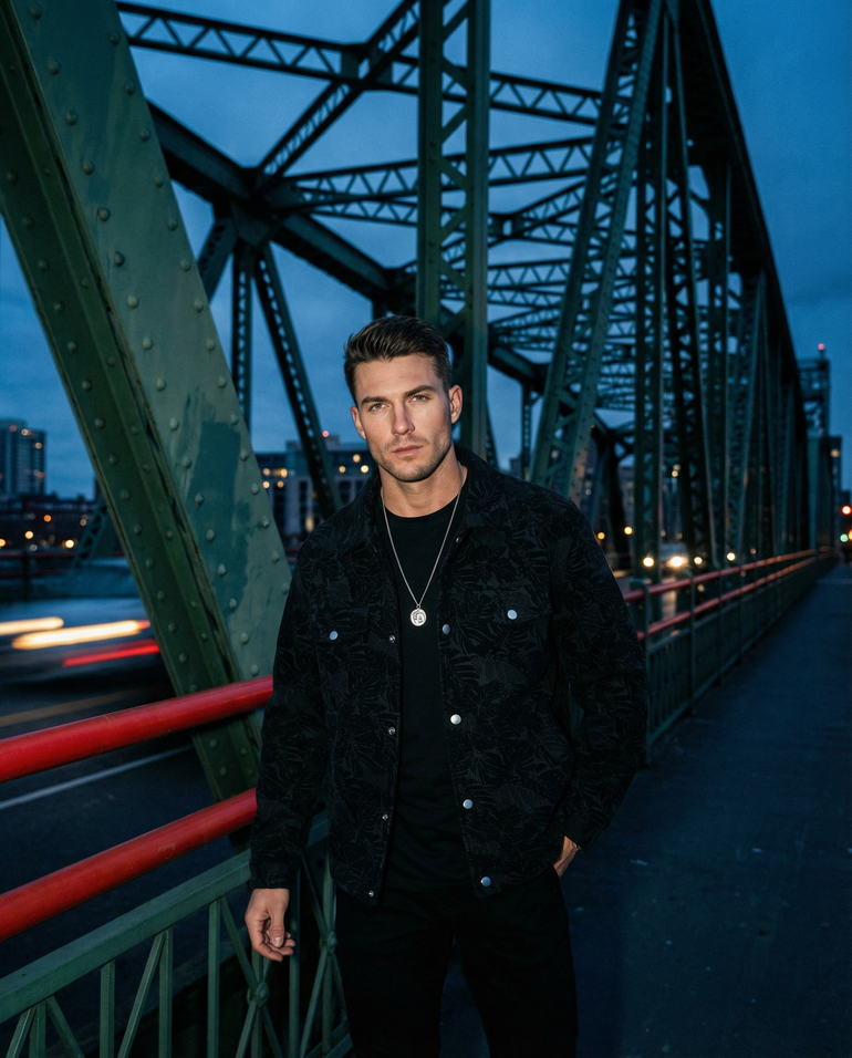 Male model on bridge wearing the Barevici Turin corduroy jacket men’s plus size snap down casual layer black